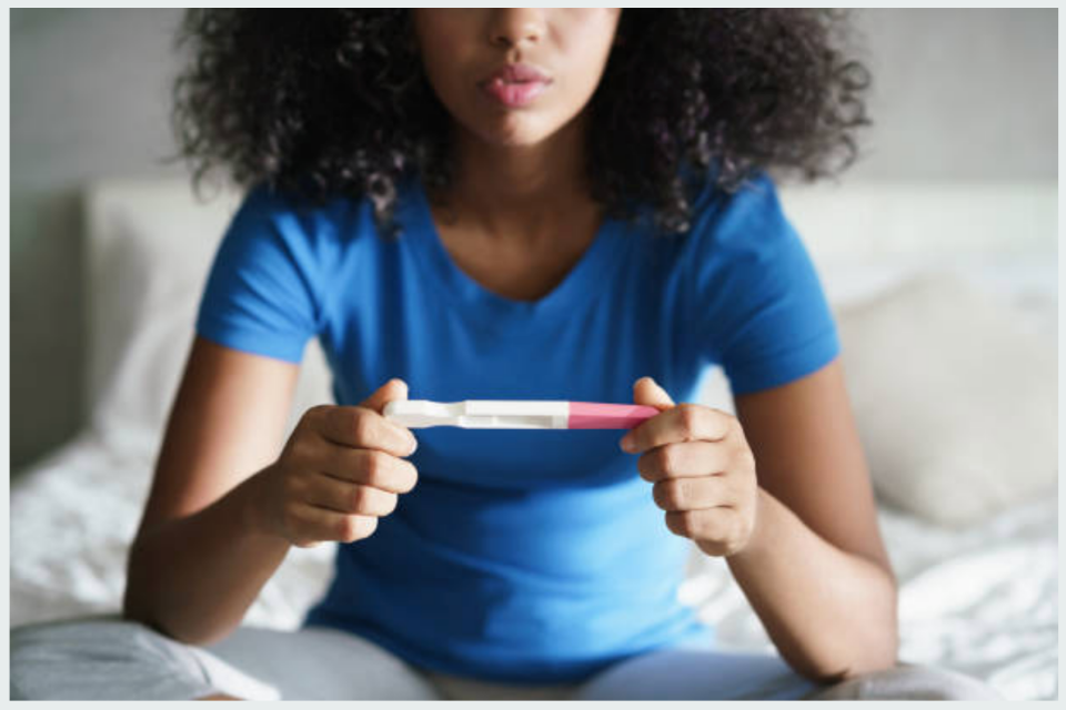 Woman Looking at Pregnancy Test